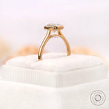 Low profile bezel setting highlighting cushion cut diamond