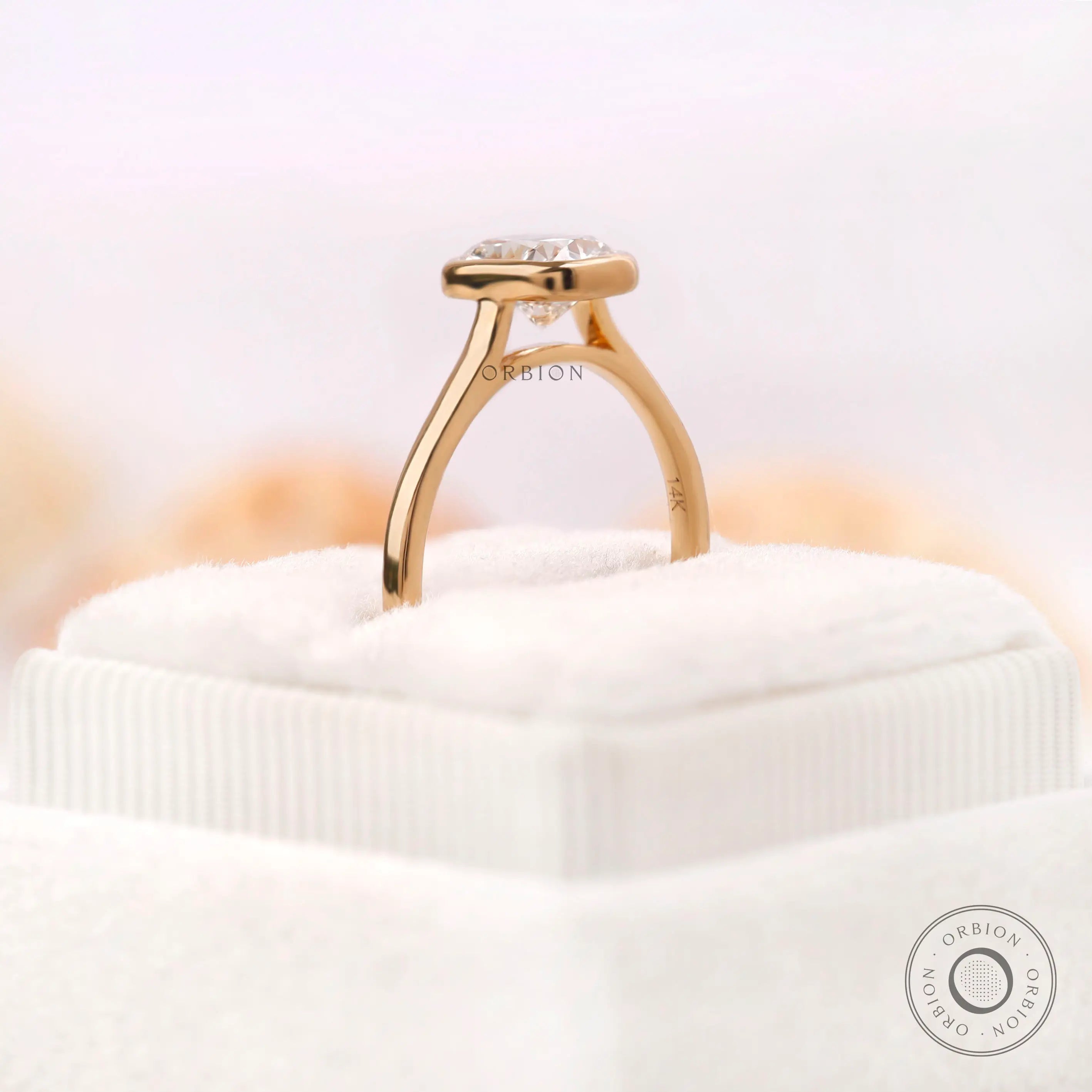 Low profile bezel setting highlighting cushion cut diamond