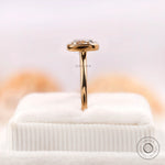 Bezel set cushion diamond ring displayed upright