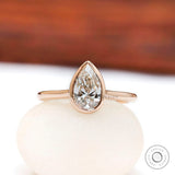 Pear cut lab grown diamond bezel cathedral solitaire ring front view