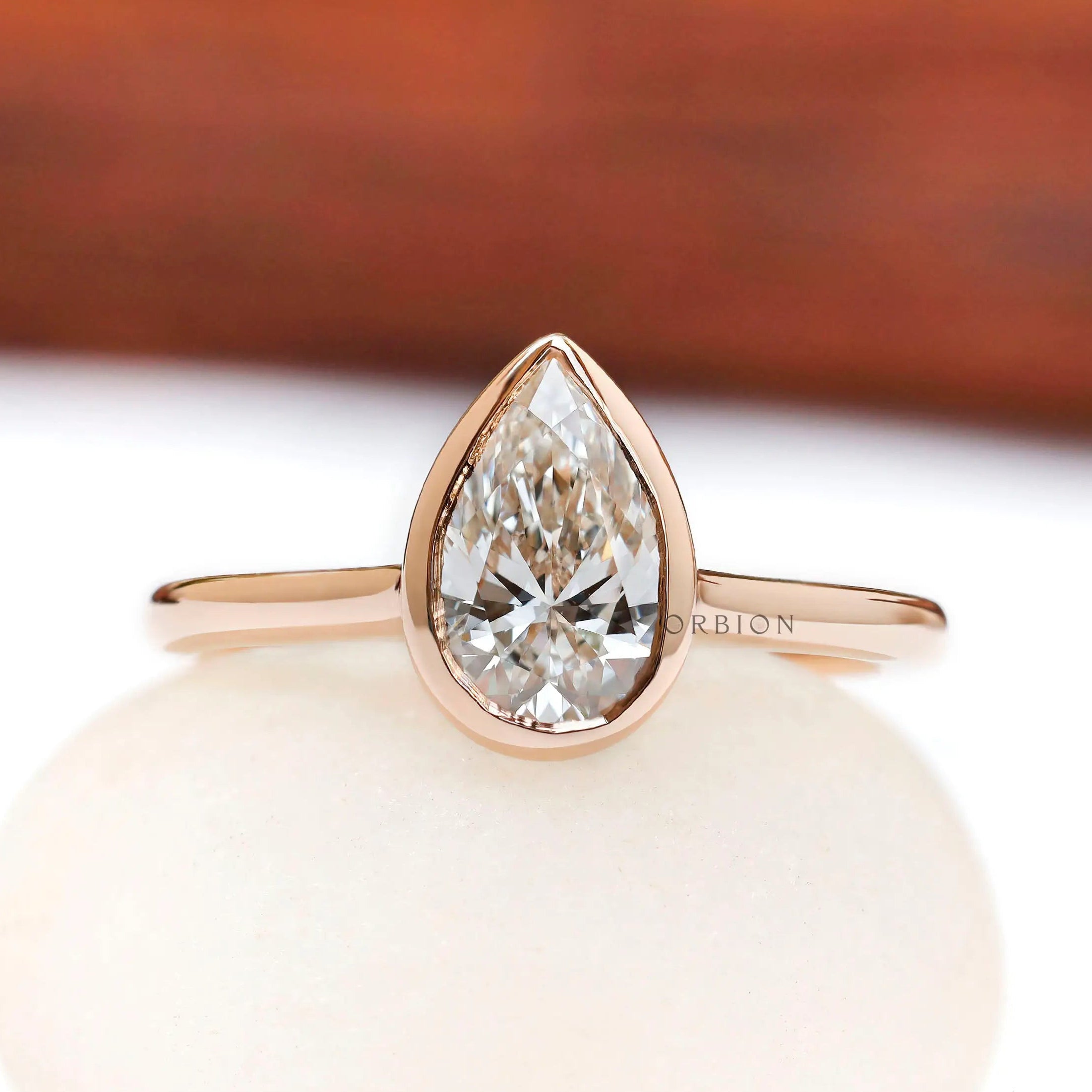 Pear cut lab grown diamond bezel cathedral solitaire ring front view
