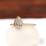 Pear shaped lab grown diamond bezel cathedral ring straight-on view