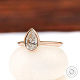 Pear shaped lab grown diamond bezel cathedral ring straight-on view