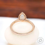 Rear view of pear bezel cathedral solitaire ring