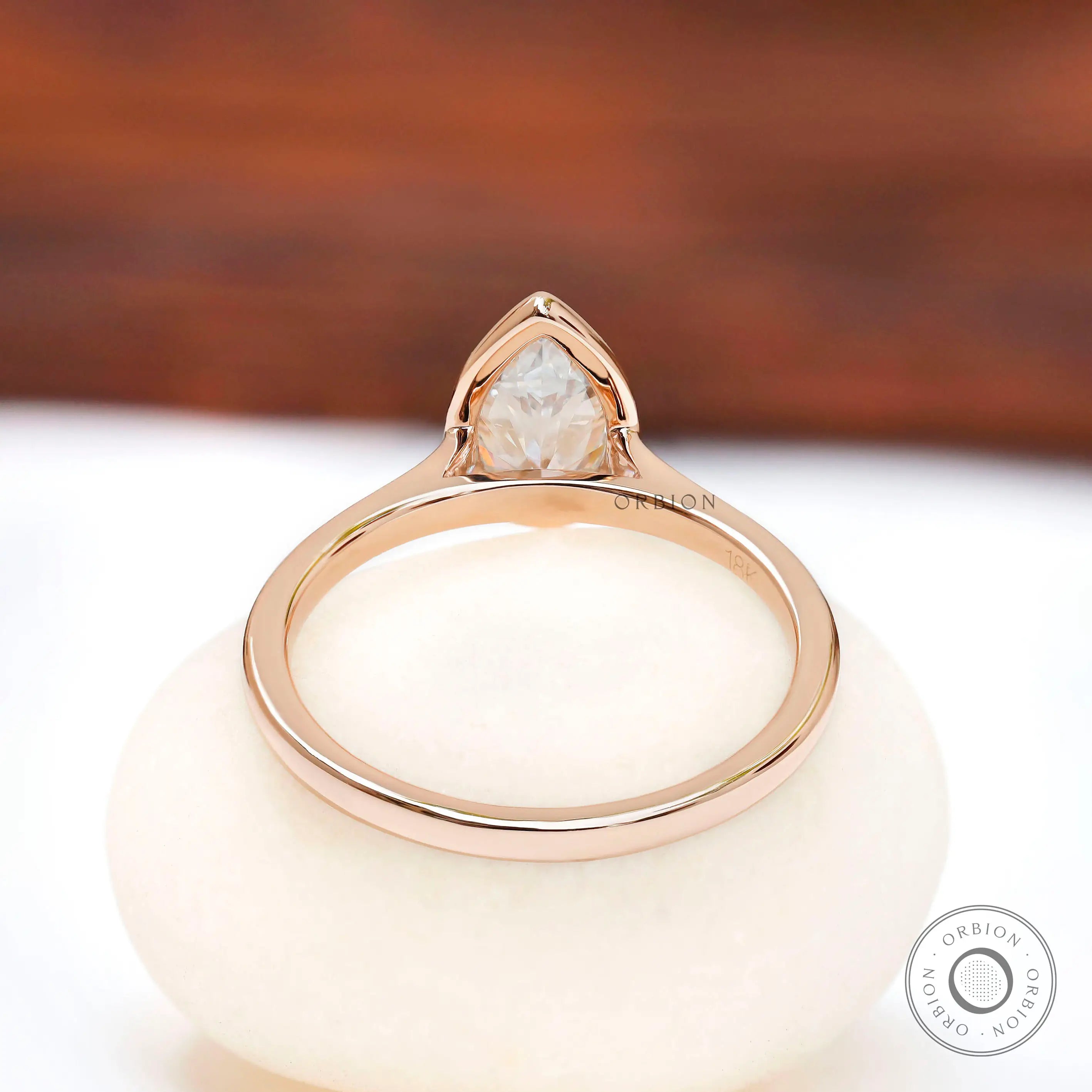 Rear view of pear bezel cathedral solitaire ring