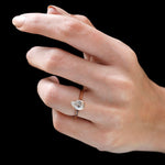 Pear cut bezel cathedral diamond ring worn on hand angled view