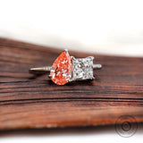 Pear pink diamond and white diamond ring top view