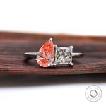 Two stone lab grown diamond ring on wooden surface