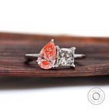 Two stone lab grown diamond ring on wooden surface