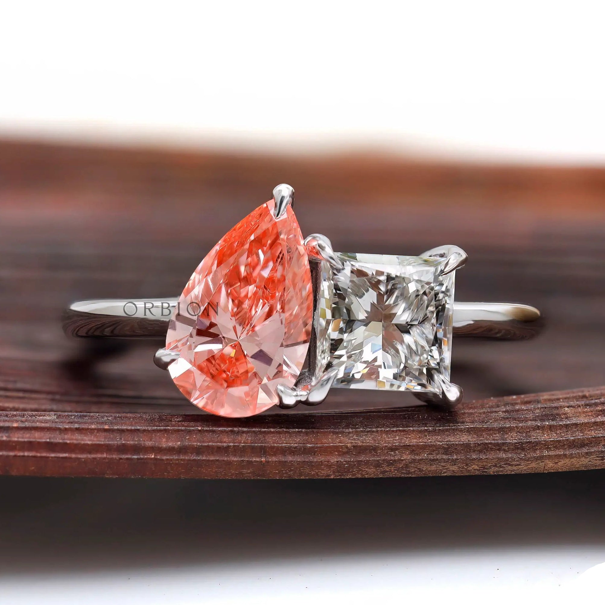 Two stone lab grown diamond ring on wooden surface