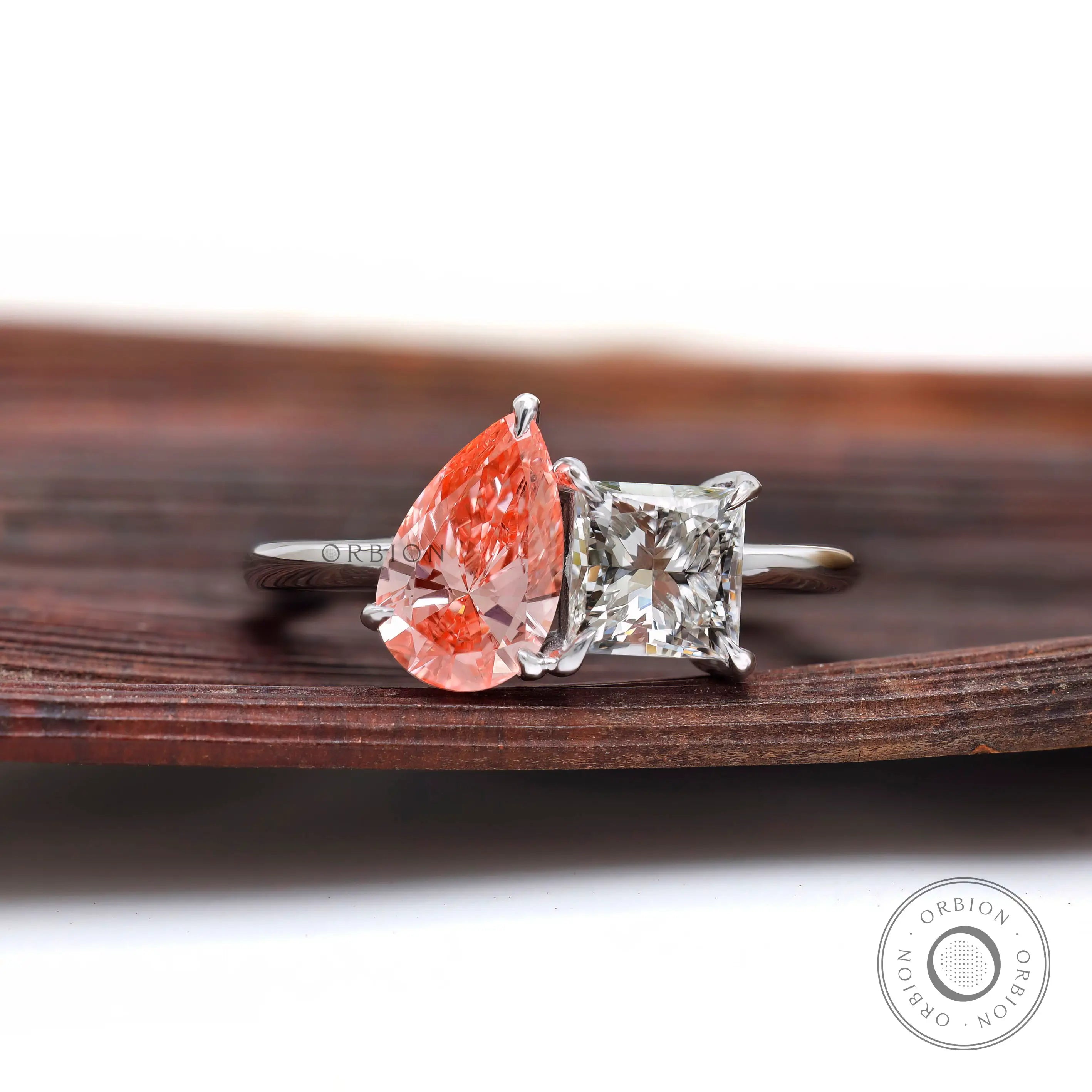 Two stone lab grown diamond ring on wooden surface
