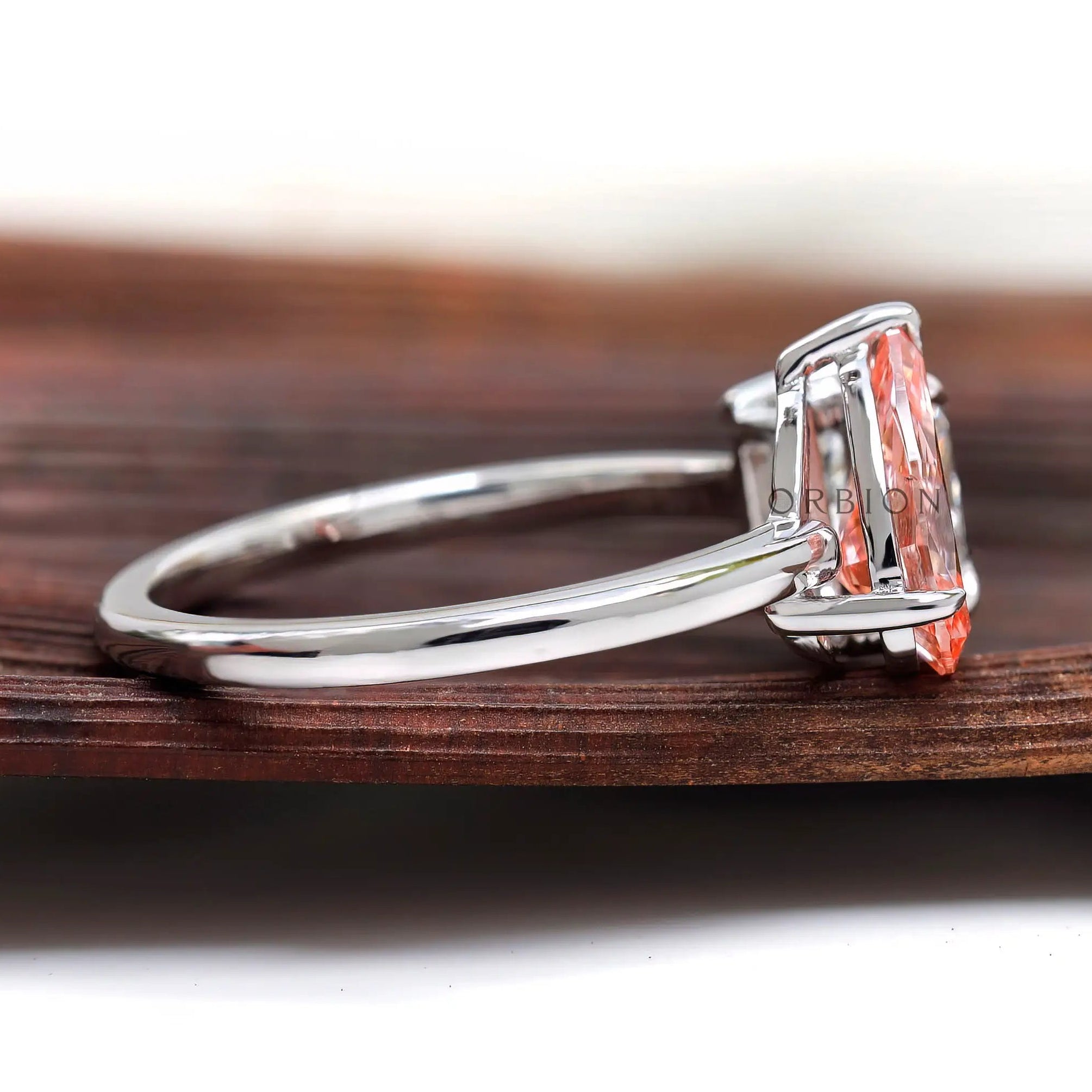 Pear pink diamond and princess diamond side view setting