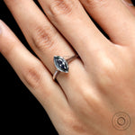 Close up of grey moissanite brilliant cut bezel setting