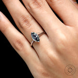 Close up of grey moissanite brilliant cut bezel setting