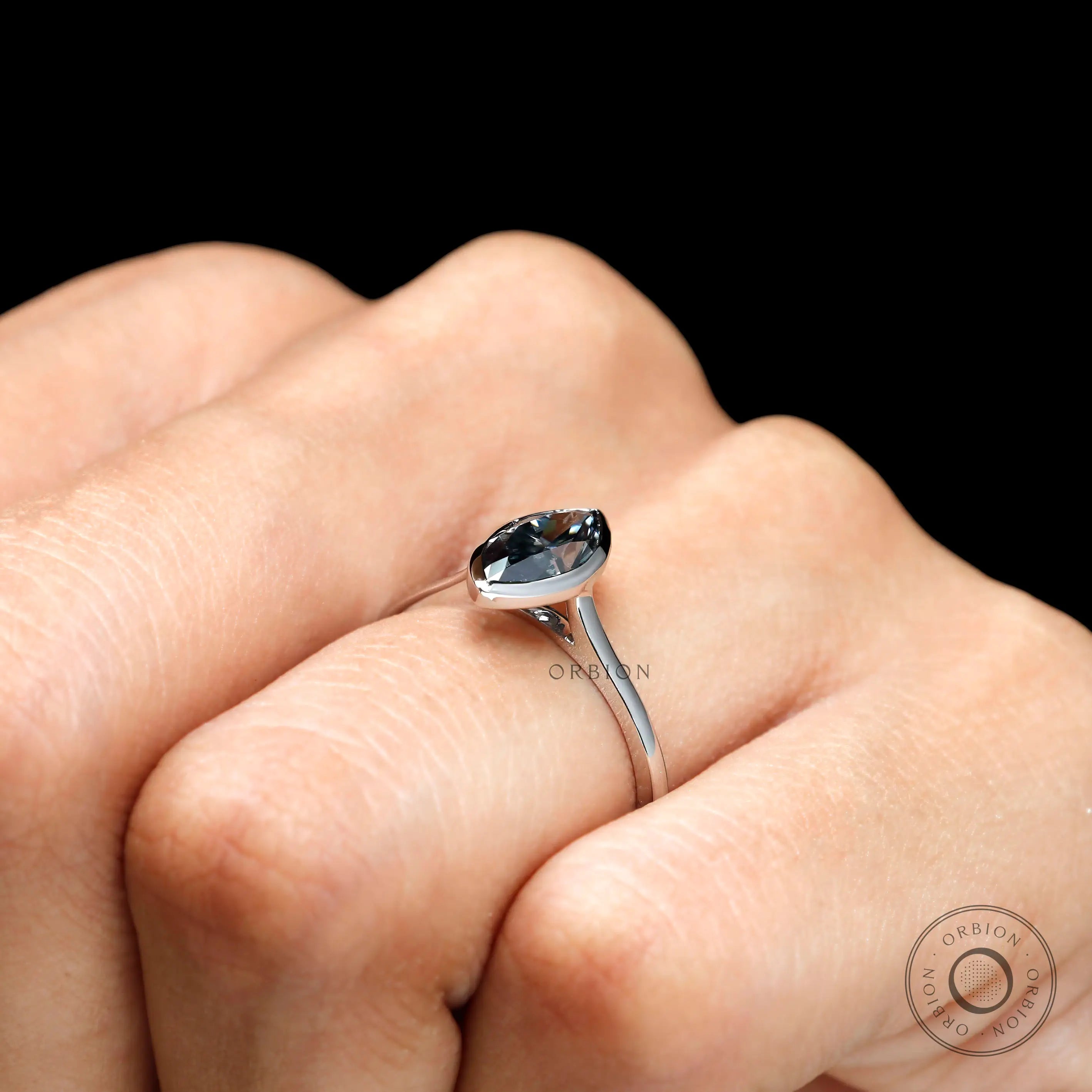Grey moissanite brilliant cut bezel setting angle view