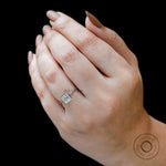 Princess cut lab grown diamond ring worn on hand against black background