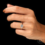 Cushion cut solitaire engagement ring in 14K yellow gold on fingure