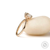 Profile view of yellow gold solitaire ring highlighting elevated prong setting and slim band