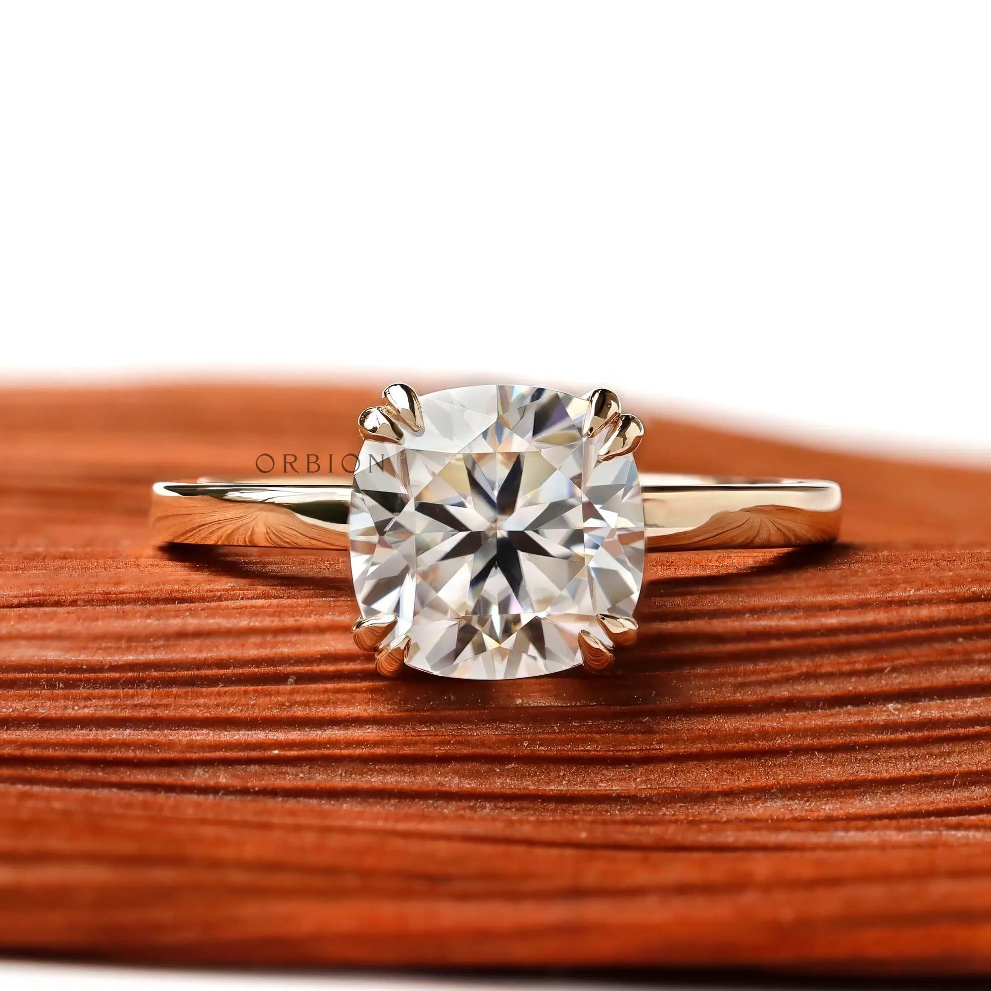 Cushion cut solitaire engagement ring in 14K yellow gold with glossy finish, front view