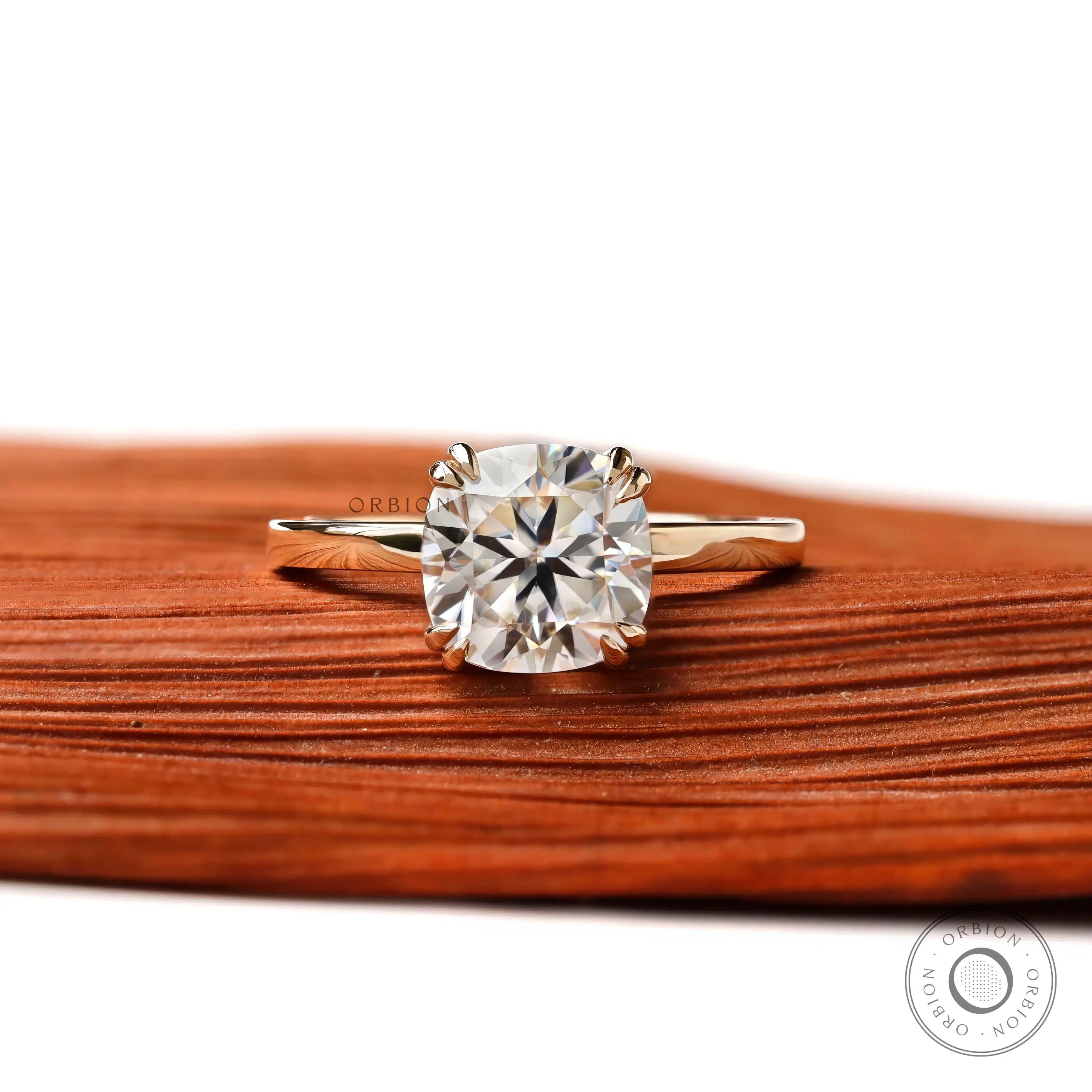 Cushion cut solitaire engagement ring in 14K yellow gold with glossy finish, front view