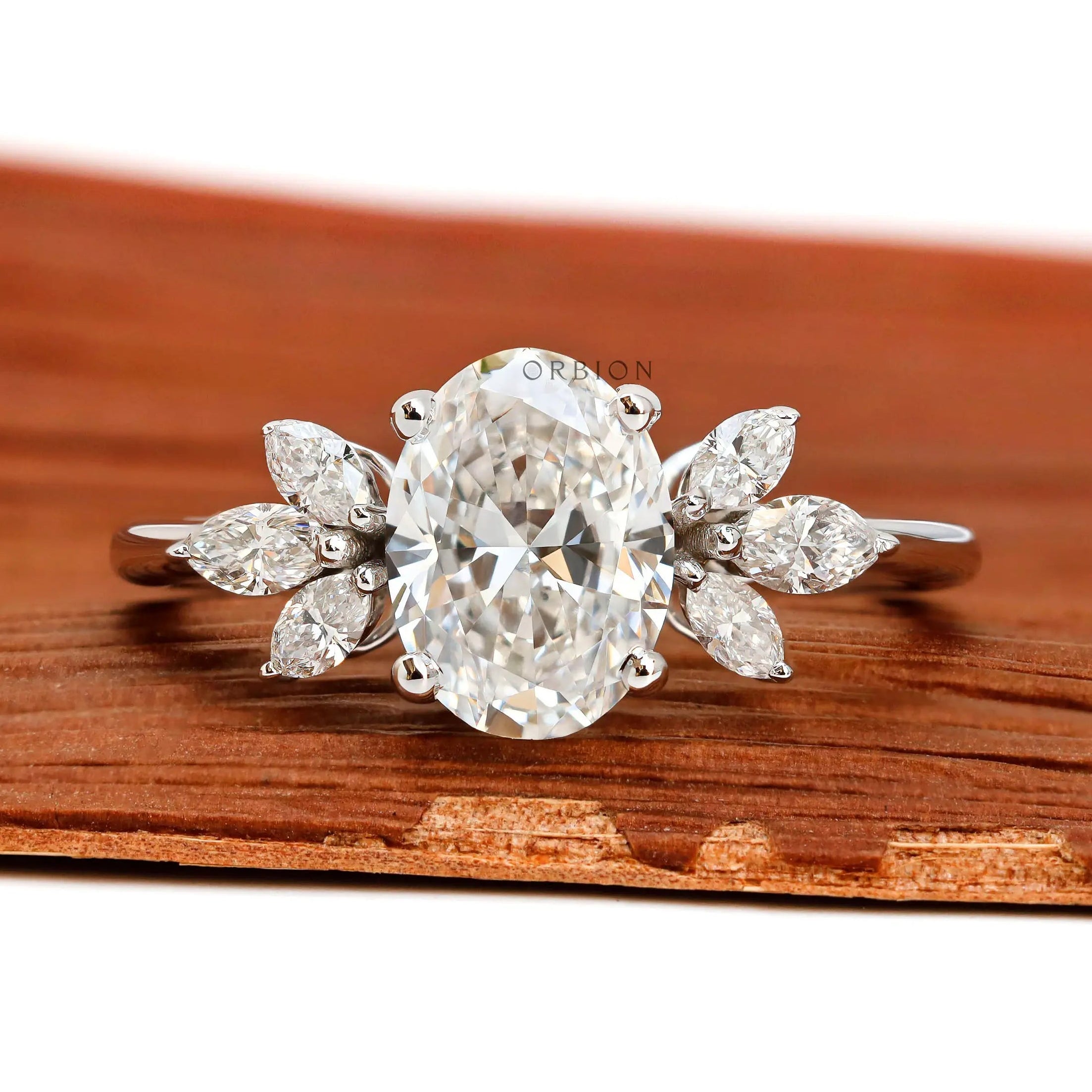 Oval cut floral solitaire engagement ring with marquise side stones