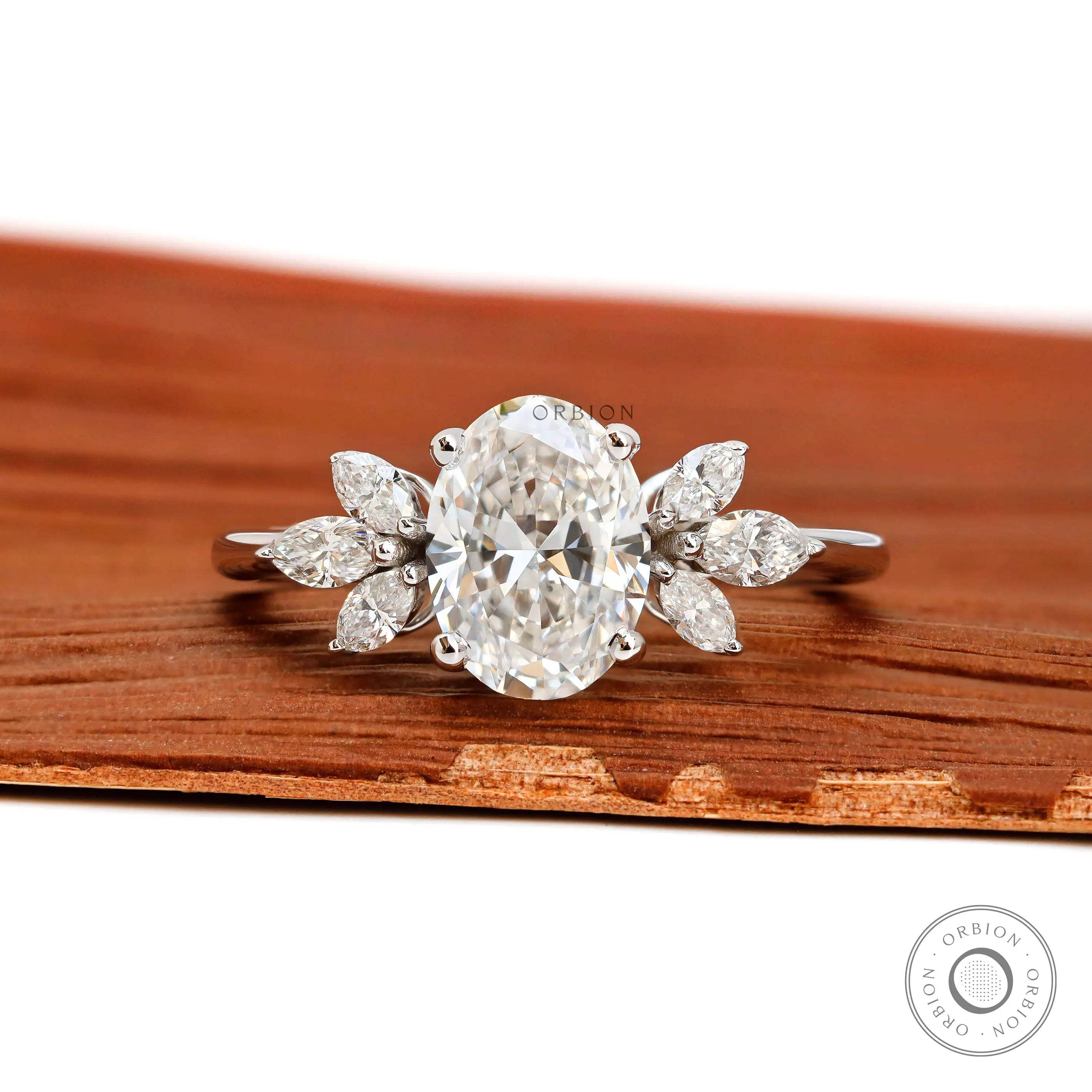 Oval cut floral solitaire engagement ring with marquise side stones