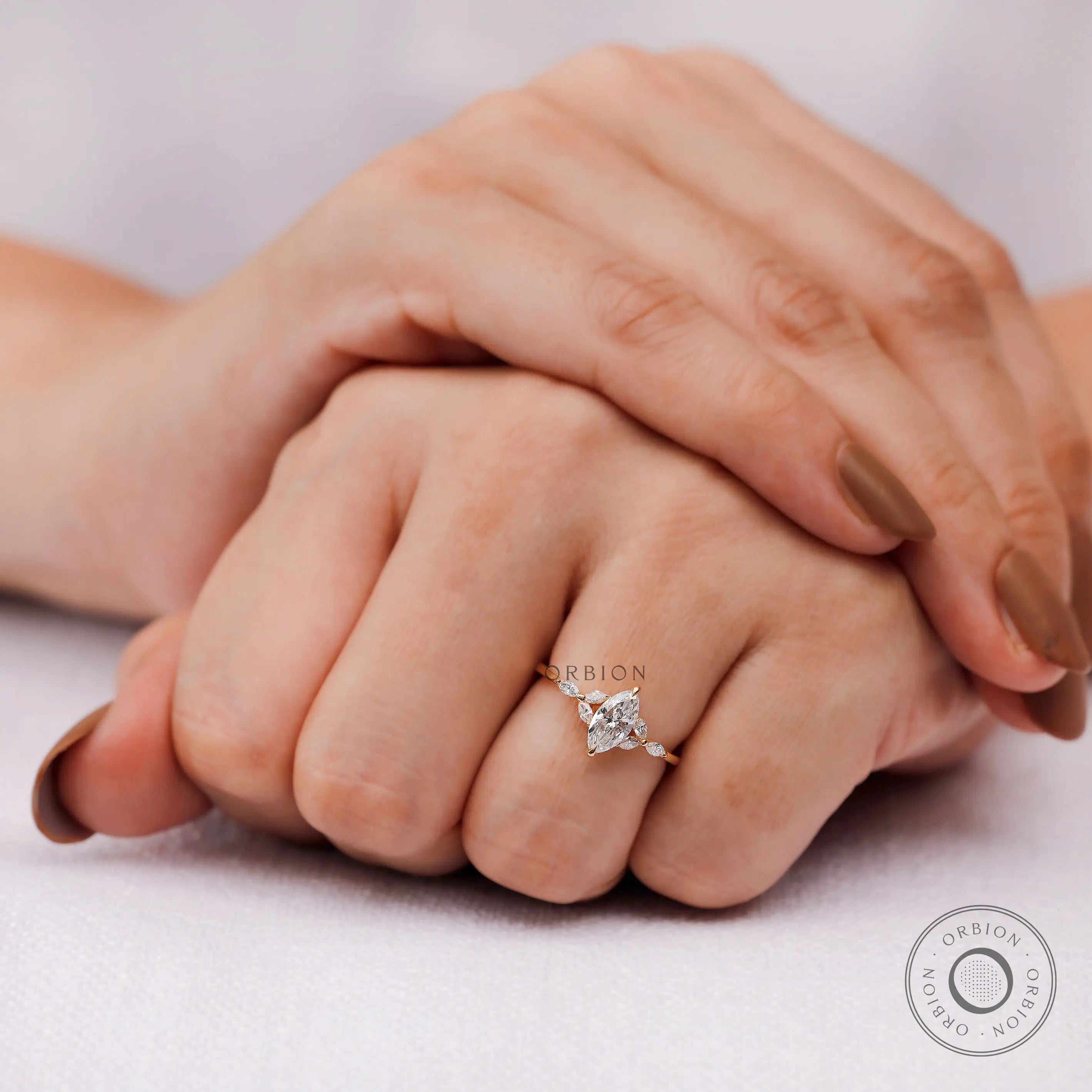Marquise diamond cluster ring worn on hand