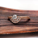 Rose gold round diamond engagement ring with curved halo detail