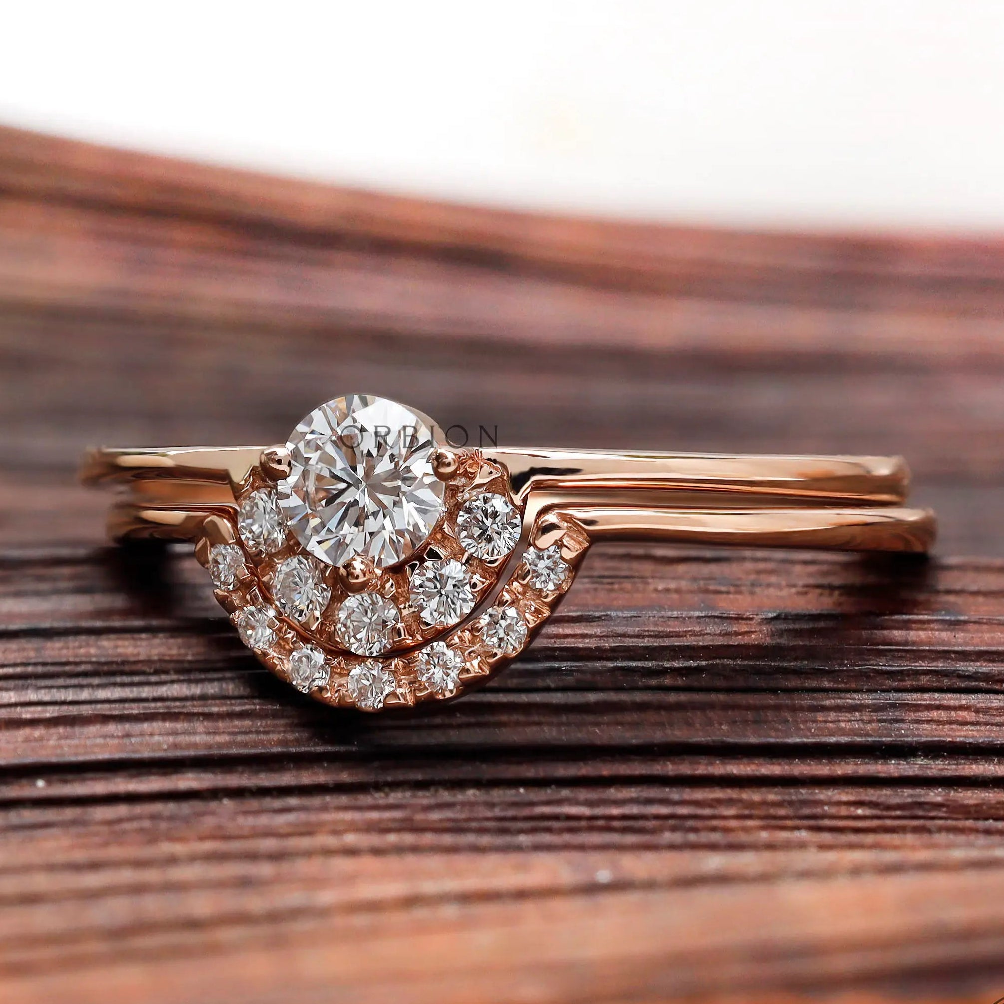 Rose gold round diamond engagement ring with curved halo detail