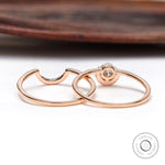 Diamond halo engagement ring set displayed on wooden surface