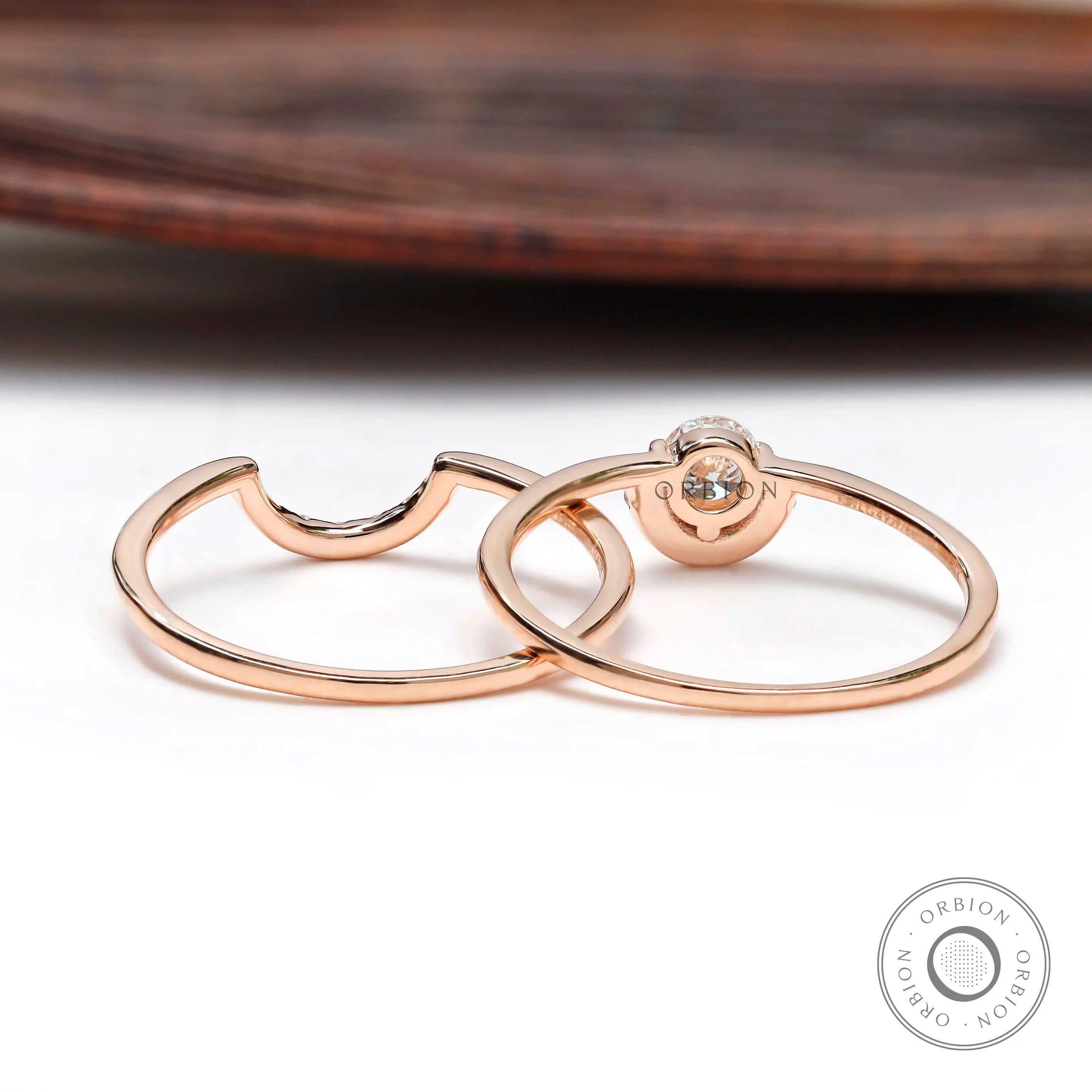 Diamond halo engagement ring set displayed on wooden surface