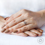 Rose gold diamond engagement ring worn on hand