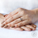 Rose gold diamond engagement ring worn on hand