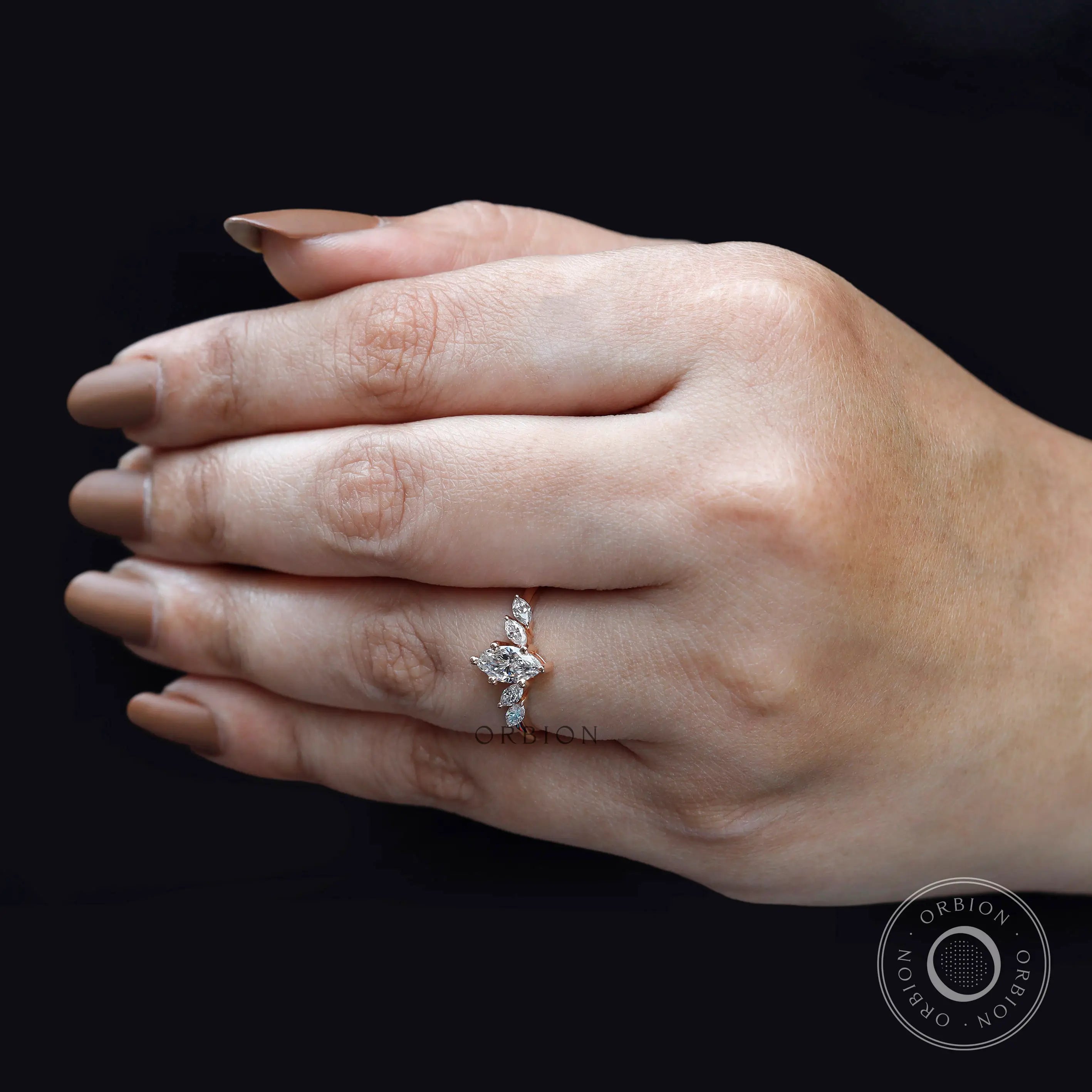 Delicate rose gold marquise cluster ring lifestyle image