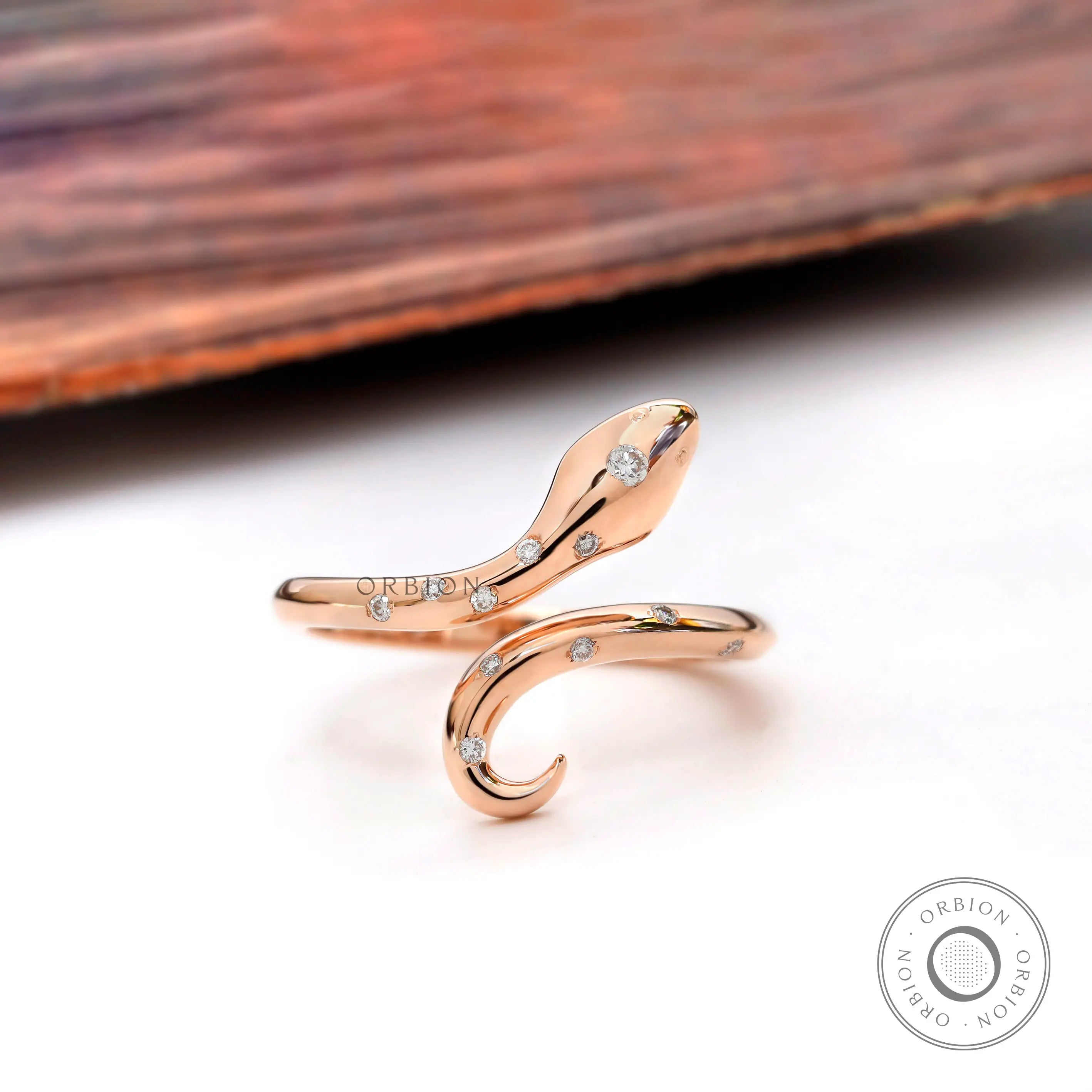 Diamond snake ring in 14K rose gold with open bypass design