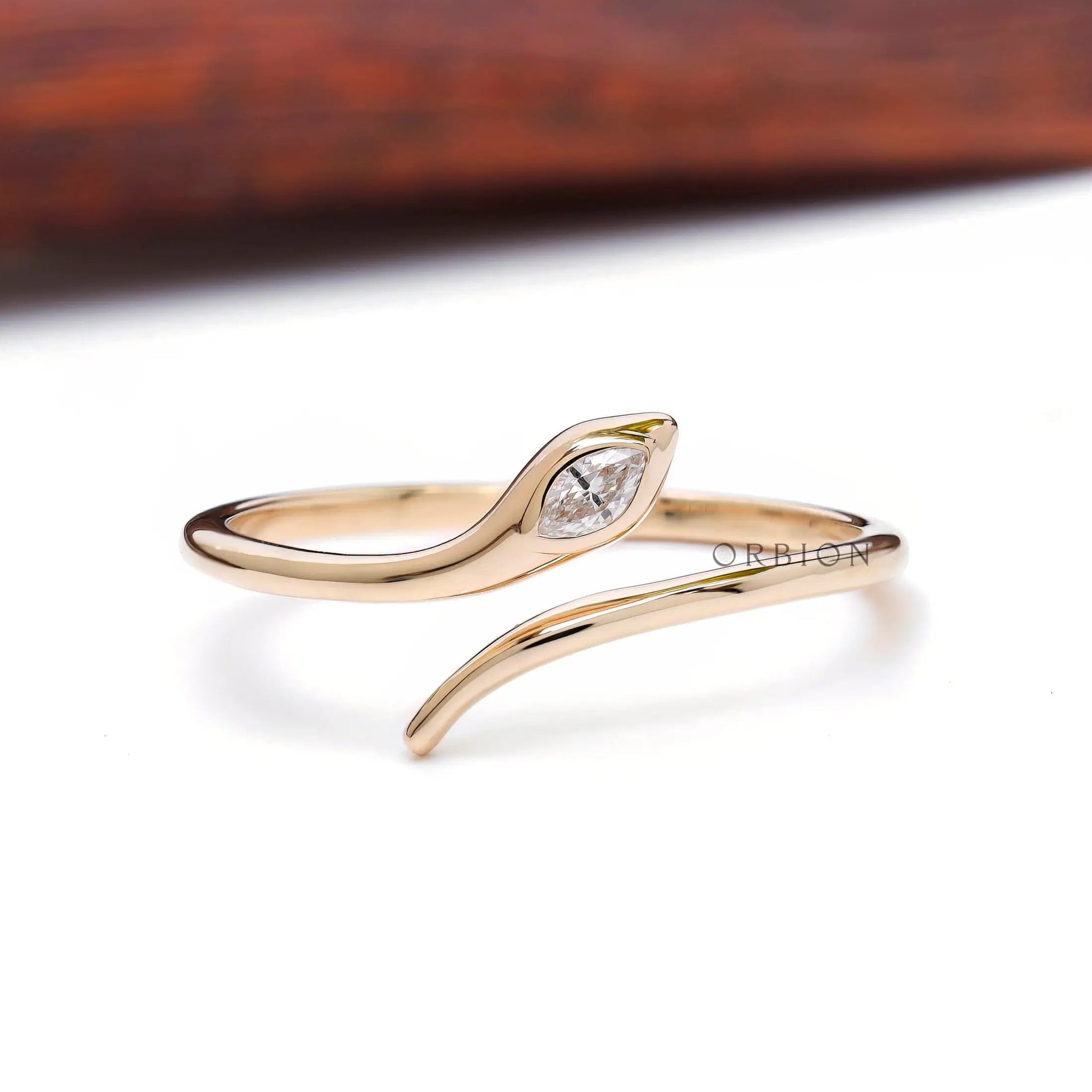 Snake ring in 14K yellow gold with marquise diamond
