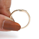 Thin yellow gold snake ring with fluid curved design