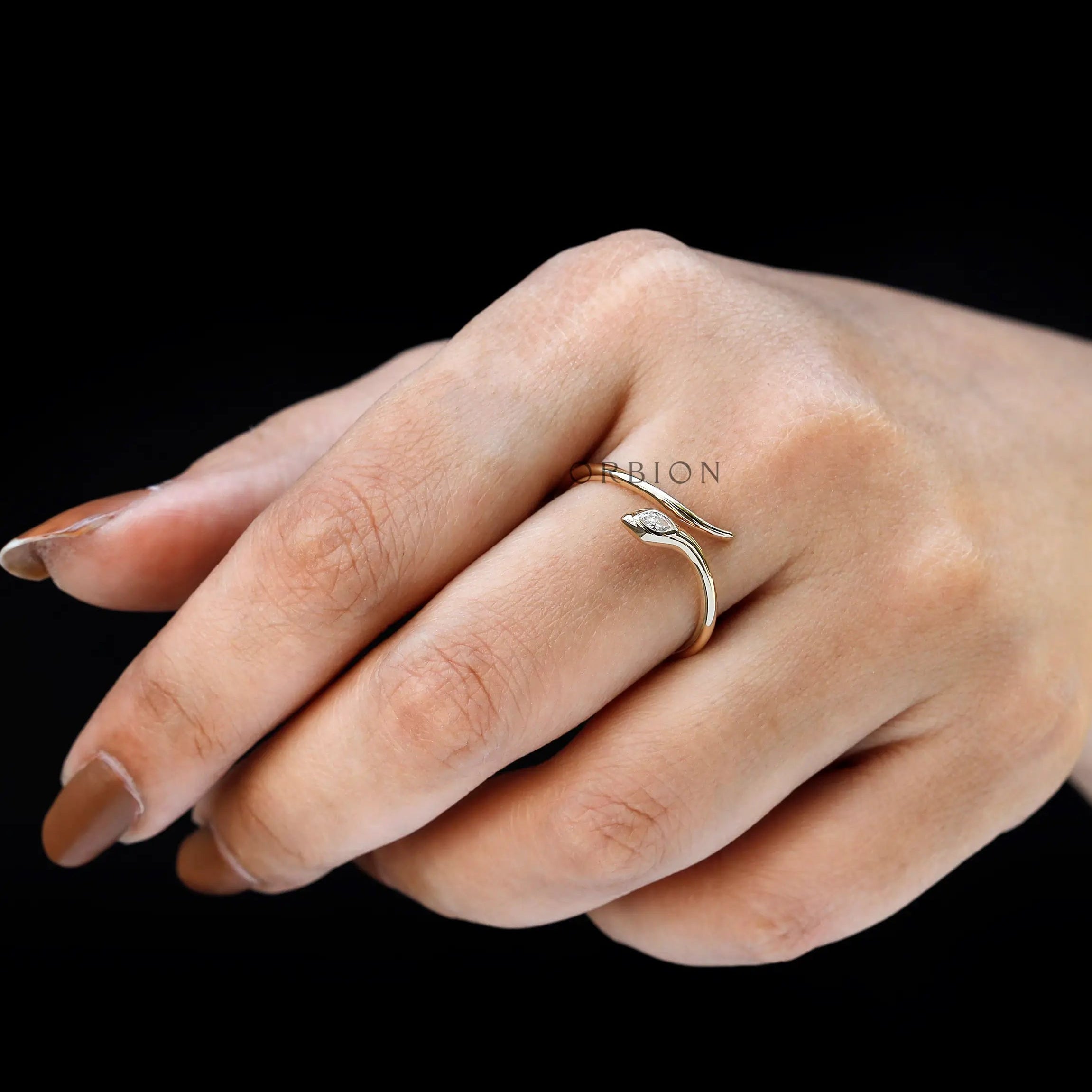 Elegant snake ring with marquise diamond on hand