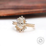 Yellow gold oval diamond cluster ring with matching band