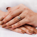 Close-up of oval diamond with round halo accent stones