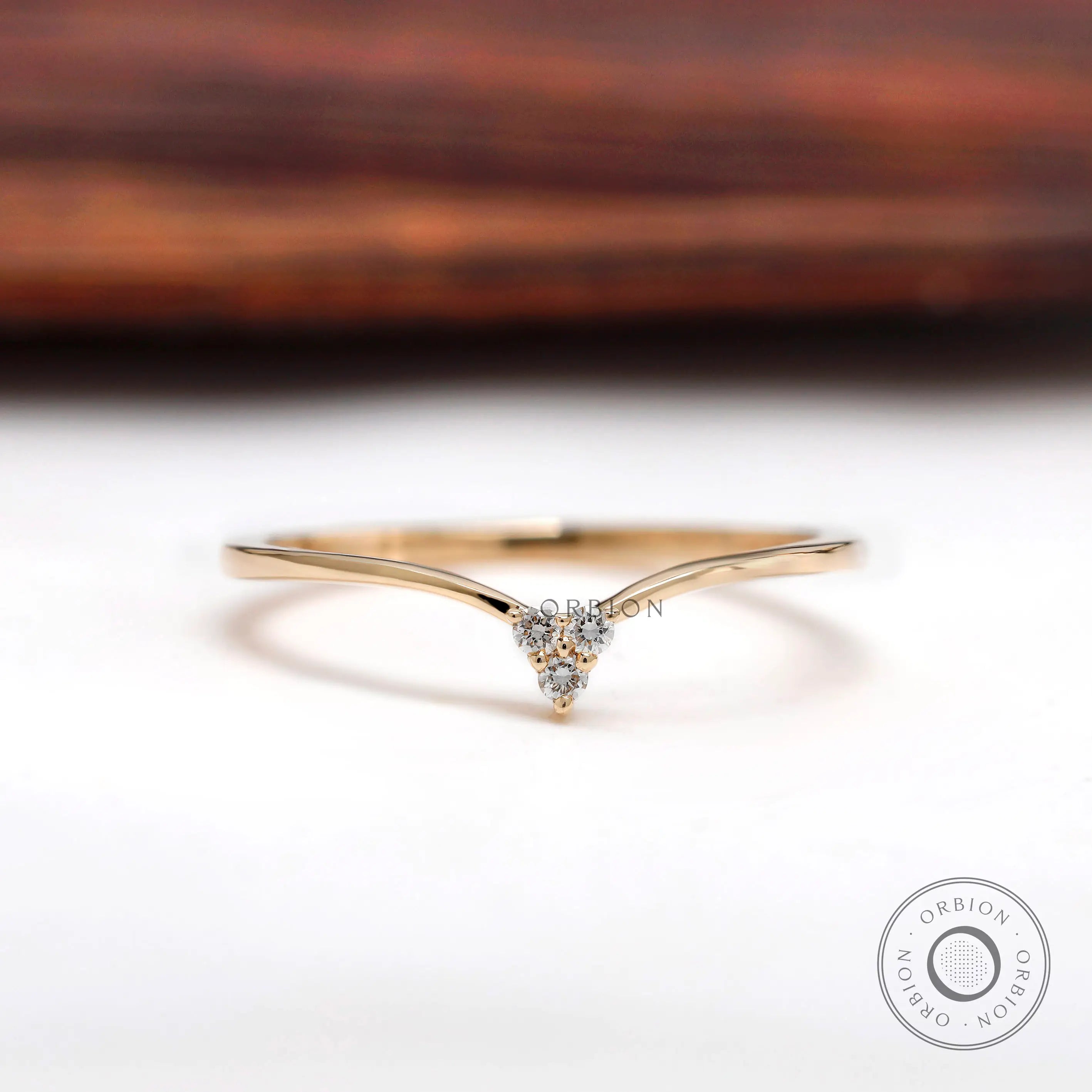 Delicate chevron band with round diamond cluster in yellow gold