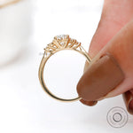 Elegant oval cluster ring with tapered yellow gold band