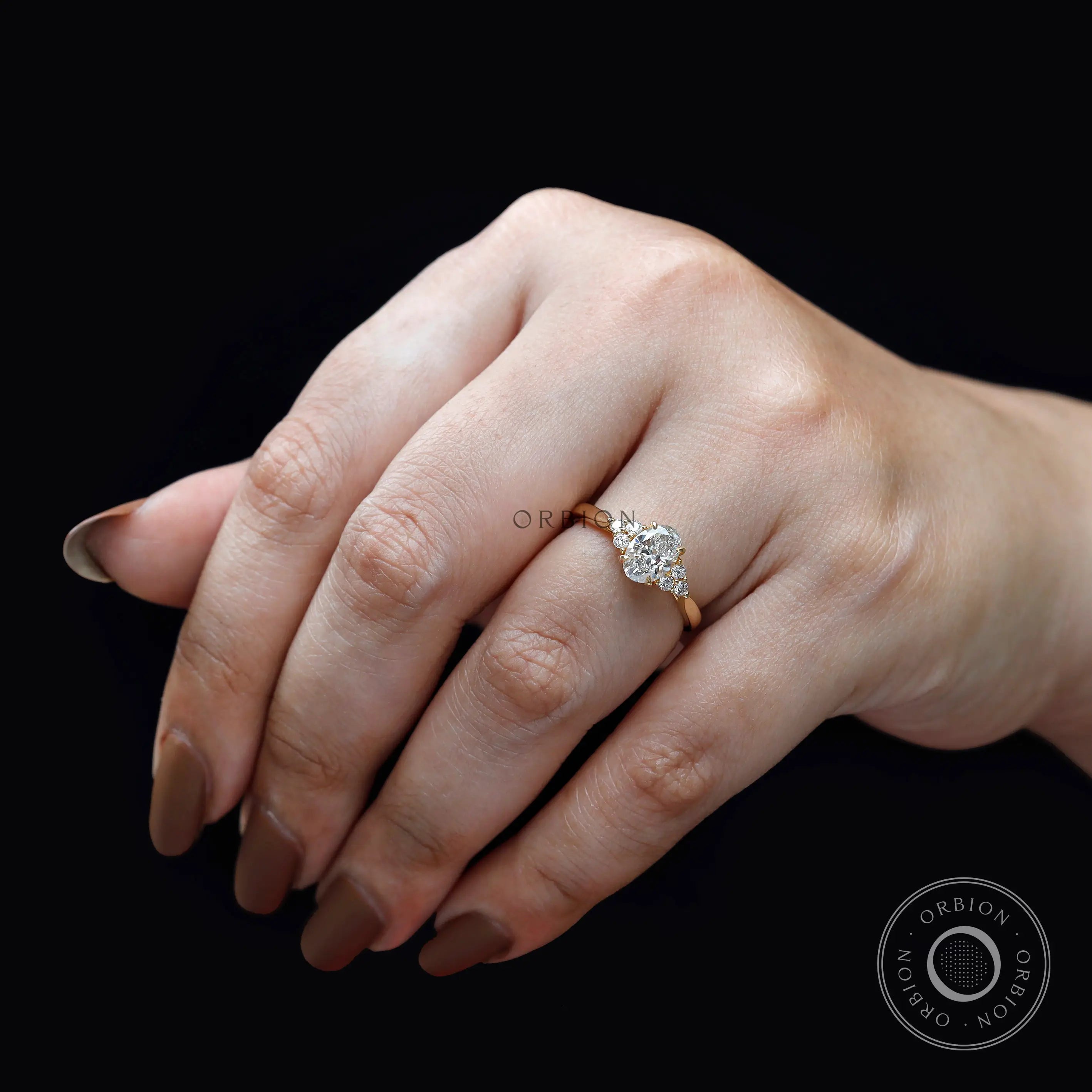 Oval lab grown diamond cluster ring worn on hand