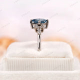 Cluster style engagement ring with blue princess cut diamond and moissanite accents