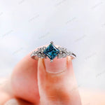 Close-up of fancy vivid blue princess cut diamond cluster setting