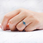 Top view of princess cut blue diamond cluster engagement ring