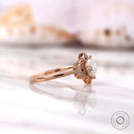 Rose gold floral halo engagement ring angled view