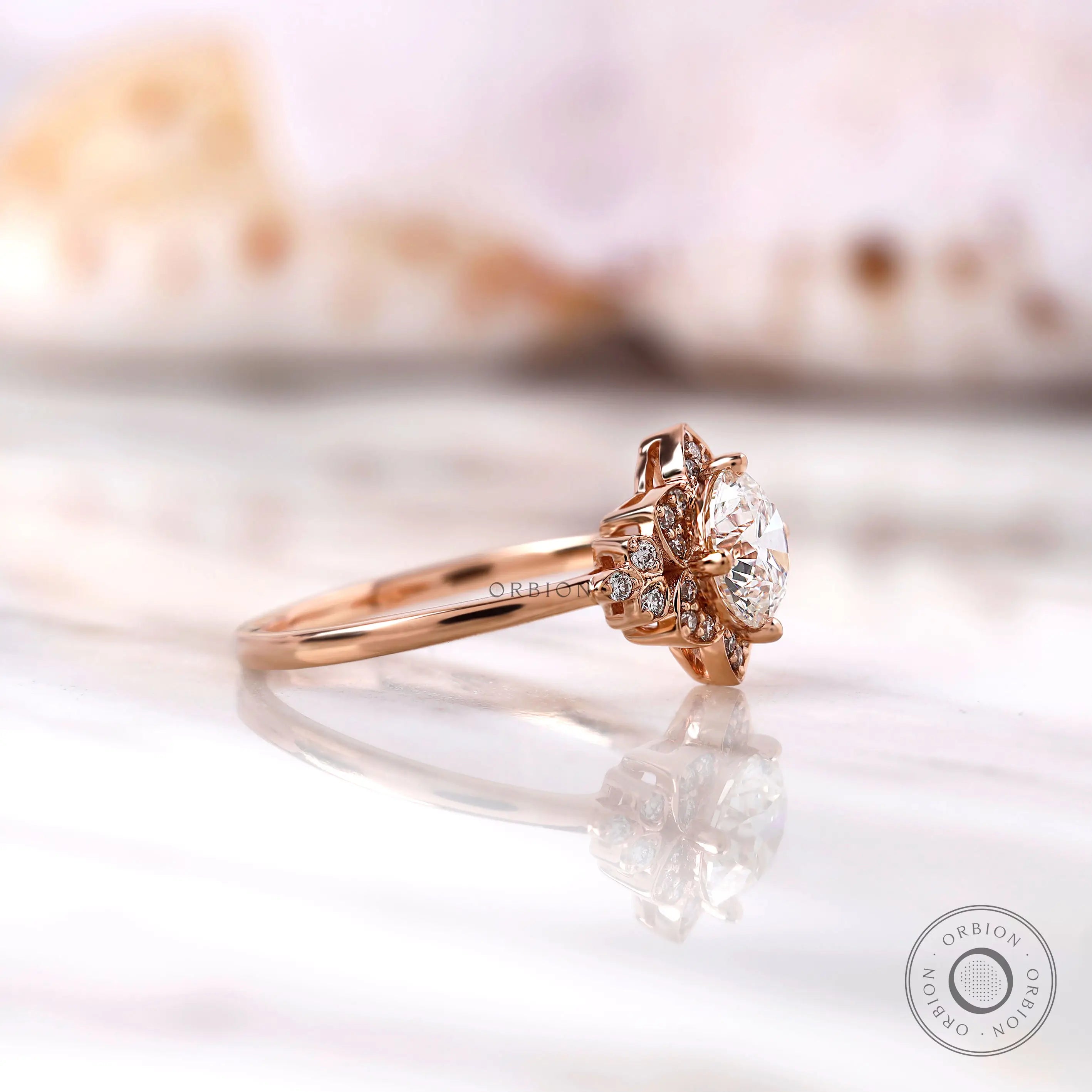 Rose gold floral halo engagement ring angled view