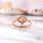 Lab grown diamond halo ring showing petal-inspired setting