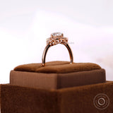 Round diamond halo ring with accent stones in rose gold band